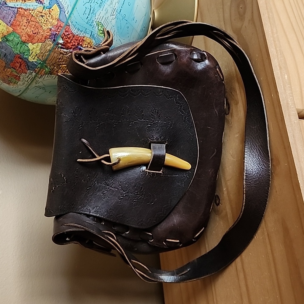 Vintage hand tooled leather shoulder bag with horn toggle closure